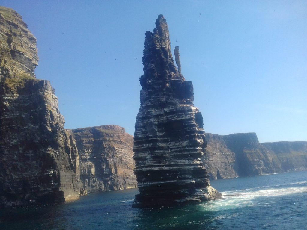 The spectacular view of the Ciffs of Moher from the ocean below them